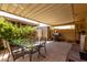 Covered patio with a dining table, chairs and a grill for outdoor entertaining at 7665 E Montecito Ave, Scottsdale, AZ 85251