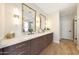 Bright bathroom features a double sink vanity with modern fixtures, and wooden style floors at 7705 E Doubletree Ranch Rd # 8, Scottsdale, AZ 85258