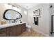 Modern bathroom featuring an oval mirror, stylish wooden vanity, and contemporary fixtures at 7705 E Doubletree Ranch Rd # 8, Scottsdale, AZ 85258
