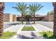 Well-maintained building exterior featuring desert landscaping, palm trees, and symmetrical design elements for a welcoming community at 7705 E Doubletree Ranch Rd # 8, Scottsdale, AZ 85258