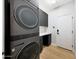 Sleek laundry room with front loading machines, gray cabinets and wood style flooring at 7705 E Doubletree Ranch Rd # 8, Scottsdale, AZ 85258