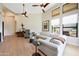 Spacious living room featuring a fireplace, light wood floors and a vaulted ceiling with fans at 7705 E Doubletree Ranch Rd # 8, Scottsdale, AZ 85258