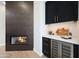 Contemporary living room with a modern fireplace, dry bar with a wine cooler and black cabinets at 7705 E Doubletree Ranch Rd # 8, Scottsdale, AZ 85258