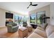 Bright living room featuring comfortable seating, light wood floors and a view of the backyard pool and golf course at 7705 E Doubletree Ranch Rd # 8, Scottsdale, AZ 85258