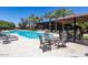 Inviting swimming pool with lounge chairs, tables, and palm trees providing a relaxing outdoor community space at 7705 E Doubletree Ranch Rd # 8, Scottsdale, AZ 85258