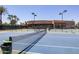 A well-kept tennis court with clear boundary lines and net and the community building in the background at 7705 E Doubletree Ranch Rd # 8, Scottsdale, AZ 85258