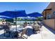 Community tennis court with shaded seating, umbrellas, and well-maintained playing surface for recreational enjoyment at 7705 E Doubletree Ranch Rd # 8, Scottsdale, AZ 85258