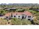 Stunning aerial view of the luxury estate with a red tile roof and mountain backdrop at 7838 N 54Th Pl, Paradise Valley, AZ 85253