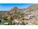 Gorgeous desert mountain home featuring red tile roof, backyard pool, surrounded by natural desert vegetation and landscape at 7838 N 54Th Pl, Paradise Valley, AZ 85253