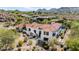 Luxury estate aerial view featuring a red tiled roof, pristine landscaping, and mountain views at 7838 N 54Th Pl, Paradise Valley, AZ 85253