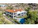 Beautiful two-story home featuring a private pool, patio area, and a lush green lawn surrounded by desert landscape at 7838 N 54Th Pl, Paradise Valley, AZ 85253