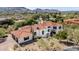Aerial view showcasing the estate with its expansive grounds, red tile roof, and mountain views at 7838 N 54Th Pl, Paradise Valley, AZ 85253