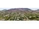 Expansive aerial view captures a desert community surrounded by lush trees, revealing the beauty of established neighborhood at 7838 N 54Th Pl, Paradise Valley, AZ 85253
