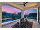 Relaxing covered balcony with ceiling fan overlooking pool, mountains, and desert sunset at 7838 N 54Th Pl, Paradise Valley, AZ 85253