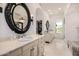 Elegant bathroom with dual vanities, ornate mirrors, walk-in closet and natural light at 7838 N 54Th Pl, Paradise Valley, AZ 85253