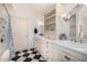 Bright bathroom with dual sinks, marble countertops, and black and white tile flooring at 7838 N 54Th Pl, Paradise Valley, AZ 85253