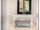 Bright bathroom featuring stylish freestanding tub, patterned bench and decorative mirror at 7838 N 54Th Pl, Paradise Valley, AZ 85253