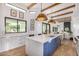 Bright kitchen featuring a large island with seating, custom cabinetry and natural lighting at 7838 N 54Th Pl, Paradise Valley, AZ 85253