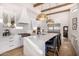 Chef's kitchen showcasing a center island with seating, modern appliances, and custom cabinetry at 7838 N 54Th Pl, Paradise Valley, AZ 85253