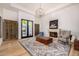 Bright living room with fireplace, elegant chandelier, and French doors leading to the outside at 7838 N 54Th Pl, Paradise Valley, AZ 85253