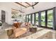 Open living room with beamed ceilings, large windows, and comfortable seating arrangement at 7838 N 54Th Pl, Paradise Valley, AZ 85253