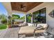 Inviting covered patio featuring comfortable seating, a ceiling fan, and views of the lush landscaping at 7838 N 54Th Pl, Paradise Valley, AZ 85253