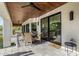 Inviting covered patio features dining table and wicker chairs plus access to the backyard at 7838 N 54Th Pl, Paradise Valley, AZ 85253