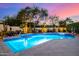 Backyard swimming pool with spa and decorative lighting, surrounded by lush landscaping and palms at 7838 N 54Th Pl, Paradise Valley, AZ 85253