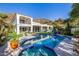 Resort-style backyard with a sparkling pool, spa, lush landscaping, and mountain views at 7838 N 54Th Pl, Paradise Valley, AZ 85253