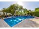 Backyard pool area featuring a sun-drenched pool, beautiful tiling, and mature shade trees at 7838 N 54Th Pl, Paradise Valley, AZ 85253