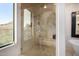 Luxurious shower features frameless glass, shower seat, multiple shower heads and desert views at 7838 N 54Th Pl, Paradise Valley, AZ 85253