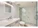 Bathroom featuring marble walled shower with glass door and vanity at 7970 E Camelback Rd # 110, Scottsdale, AZ 85251