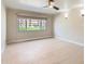 Bedroom featuring a window with views and a ceiling fan at 7970 E Camelback Rd # 110, Scottsdale, AZ 85251