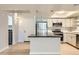Modern kitchen boasts stainless steel appliances, island and light colored cabinetry at 7970 E Camelback Rd # 110, Scottsdale, AZ 85251