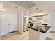 Kitchen with stainless steel appliances, light cabinetry and black marble countertops at 7970 E Camelback Rd # 110, Scottsdale, AZ 85251