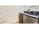 Modern washer and dryer units in a dedicated laundry area with storage shelves at 7970 E Camelback Rd # 110, Scottsdale, AZ 85251
