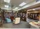 View of community library with extensive book collection, tables for puzzles and seating at 7970 E Camelback Rd # 110, Scottsdale, AZ 85251