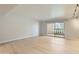 Bright living room featuring light wood floors and a sliding door with balcony access at 7970 E Camelback Rd # 110, Scottsdale, AZ 85251