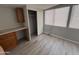 Bedroom featuring updated laminate flooring, bright light, and a built in desk at 8700 E University Dr # 1450, Mesa, AZ 85207