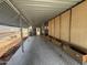 View of long carport showing a door into the main home and storage on the side at 8700 E University Dr # 1450, Mesa, AZ 85207