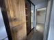 Hallway featuring mirror closet with laminate floors at 8700 E University Dr # 1450, Mesa, AZ 85207
