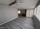 Open concept living room with ceiling fan, updated laminate flooring and natural light at 8700 E University Dr # 1450, Mesa, AZ 85207