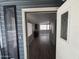 Open living room area with modern gray laminate flooring and lots of natural light at 8700 E University Dr # 1450, Mesa, AZ 85207