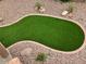 Landscaped backyard with a putting green surrounded by gravel and rocks at 8732 W Adam Ave, Peoria, AZ 85382