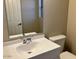 Bathroom vanity with white sink, toilet, and a large mirror at 8732 W Adam Ave, Peoria, AZ 85382