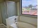 This bathroom features a walk-in shower and a separate soaking tub with window views at 8732 W Adam Ave, Peoria, AZ 85382