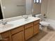 Bathroom featuring double sinks, granite countertops and wood cabinets offering storage space at 8732 W Adam Ave, Peoria, AZ 85382