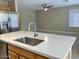 Bright kitchen featuring quartz countertops, stainless steel appliances, and a view of the living area at 8732 W Adam Ave, Peoria, AZ 85382