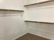 A walk-in closet with carpet and wooden clothes racks installed on the walls at 8732 W Adam Ave, Peoria, AZ 85382
