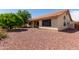 Desert landscaping and an orange tree provide a striking backdrop for the covered patio at 9123 W Utopia Rd, Peoria, AZ 85382